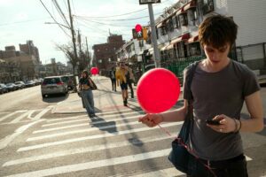 boy with red balloon street candid photography urban scene
