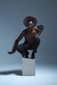 model posing on cube minimal studio fashion detail shot
