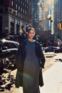 female model standing street pigeons sunlight new york fashion shoot
