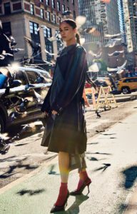 female model standing street pigeons sunlight new york fashion shoot
