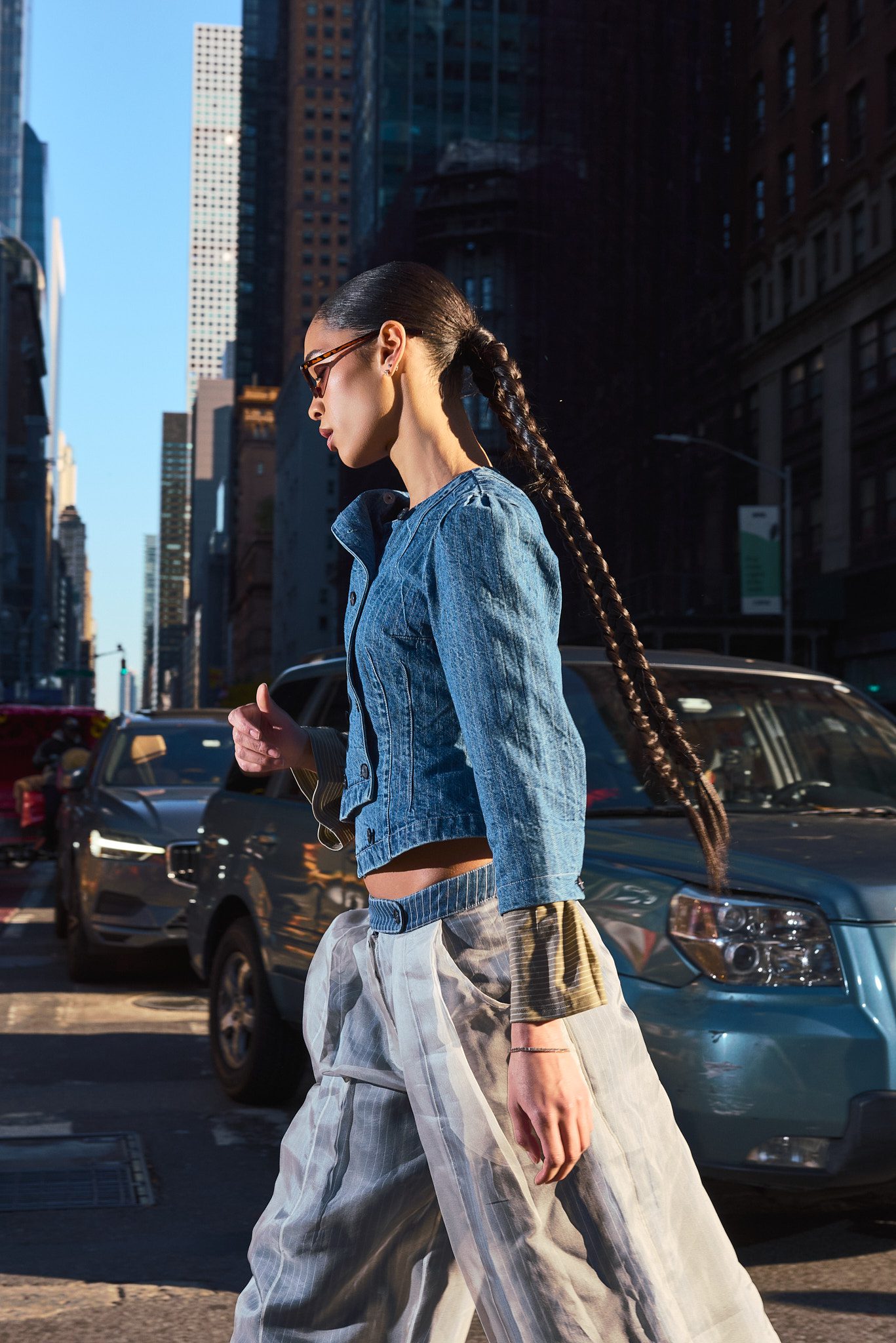 female model long braid walking city street new york fashion editorial
