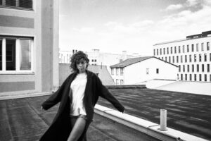 black and white rooftop portrait woman coat urban fashion photography