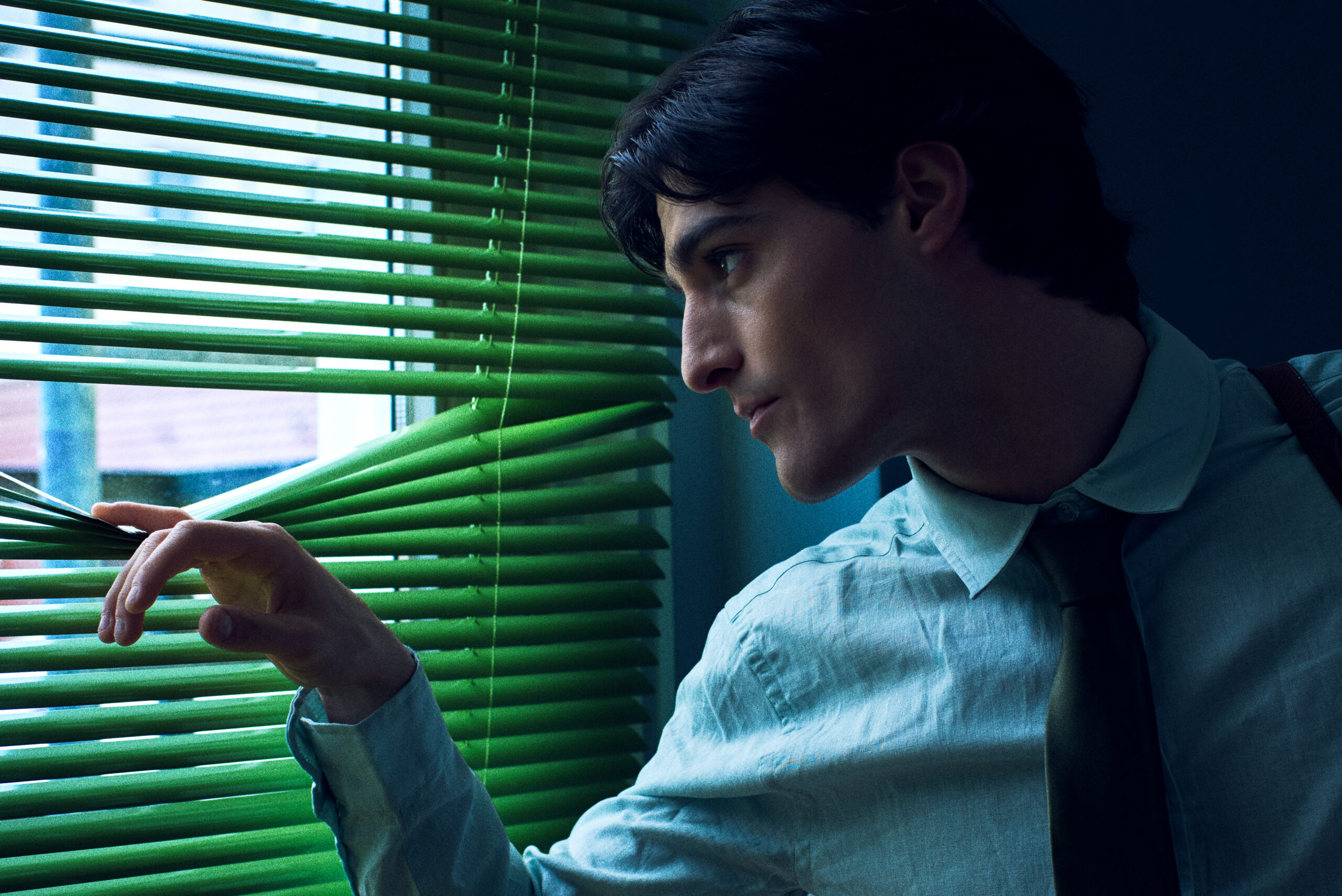 male model blue shirt office blinds green light cinematic fashion